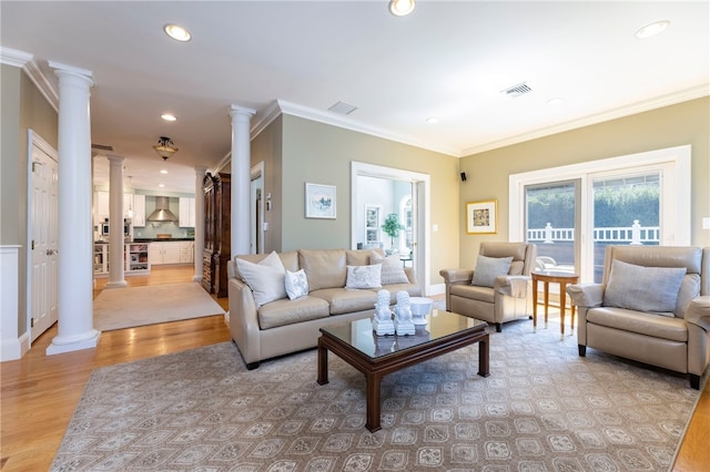 16 Central St, Charlestown, RI 02813 - living area featuring decorative columns, visible vents, light wood finished floors, ornamental molding, and recessed lighting