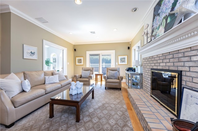 16 Central St, Charlestown, RI 02813 - living area with a brick fireplace, recessed lighting, visible vents, and ornamental molding