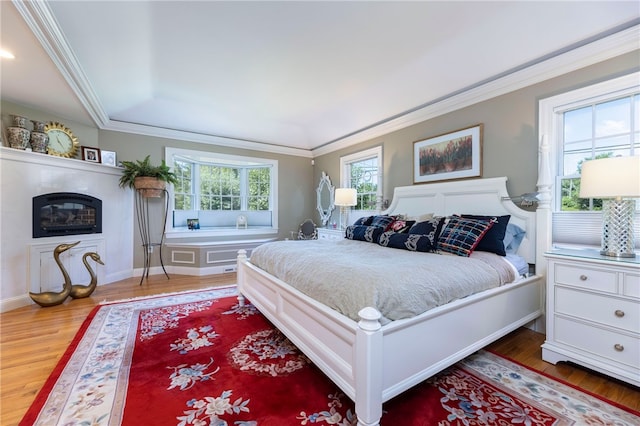 16 Central St, Charlestown, RI 02813 - bedroom with crown molding, baseboards, wood finished floors, and a fireplace