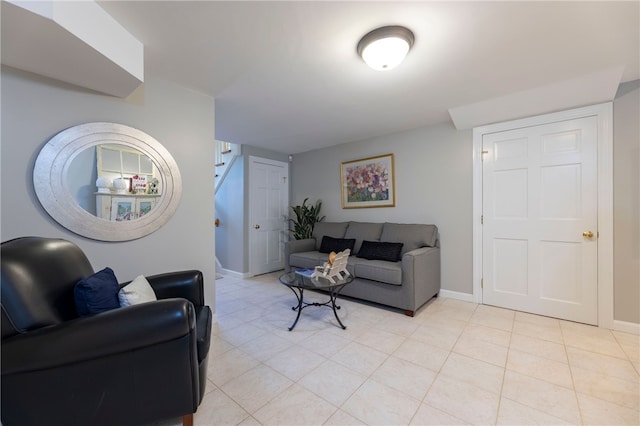 16 Central St, Charlestown, RI 02813 - living room featuring baseboards, light tile patterned floors, and stairway
