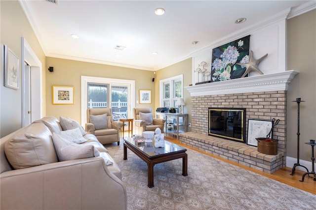 16 Central St, Charlestown, RI 02813 - living area featuring crown molding, a brick fireplace, wood finished floors, and visible vents