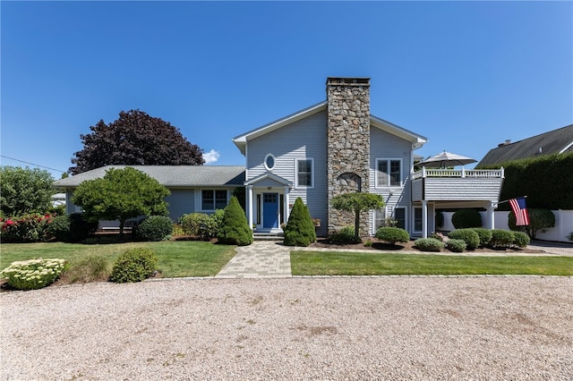 16 Central St, Charlestown, RI 02813 - view of front facade with a chimney and a front yard