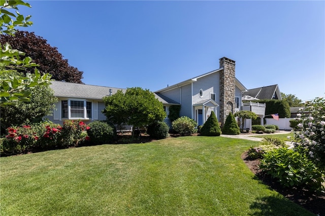16 Central St, Charlestown, RI 02813 - view of front of home featuring a chimney and a front yard