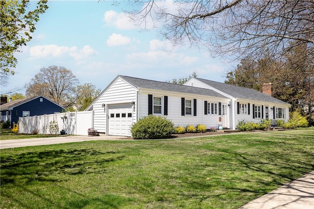 ranch-style house with fence, an attached garage, a front yard, a chimney, and driveway