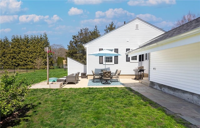 back of property featuring a lawn, a patio, outdoor lounge area, and fence