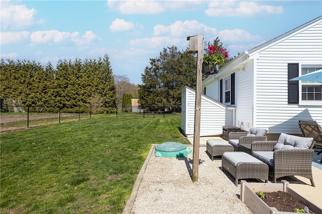 view of yard with fence, an outdoor living space, and a patio area