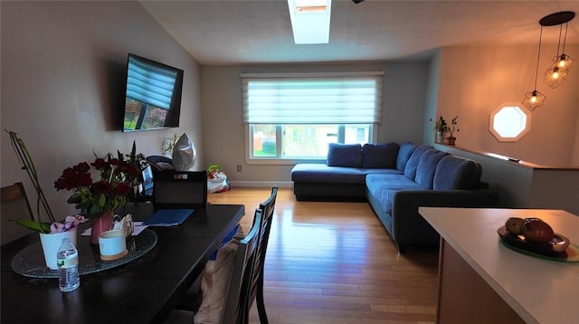 living room with baseboards, wood finished floors, and lofted ceiling