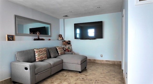 living room featuring baseboards and visible vents