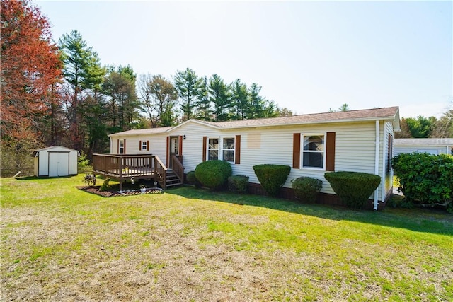view of front of home featuring an outdoor structure, a wooden deck, a storage shed, and a front yard