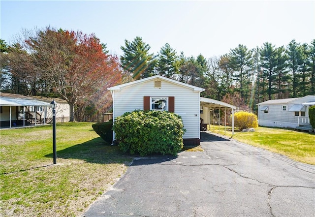 exterior space with a front lawn and aphalt driveway