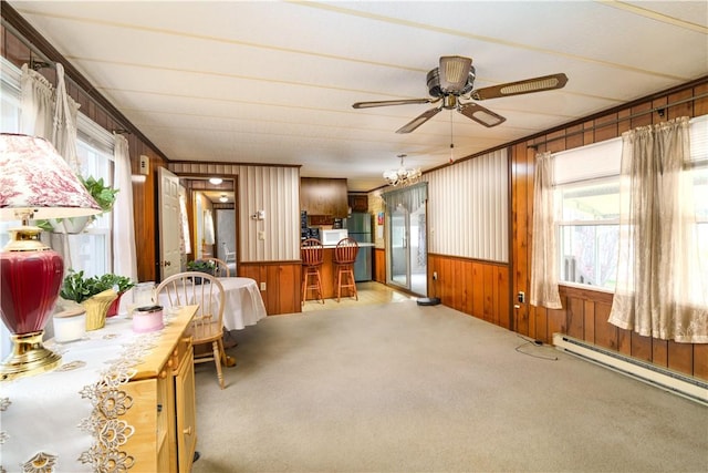 sunroom / solarium featuring a chandelier and a baseboard radiator