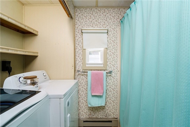 washroom featuring a baseboard heating unit, washer and dryer, and wallpapered walls