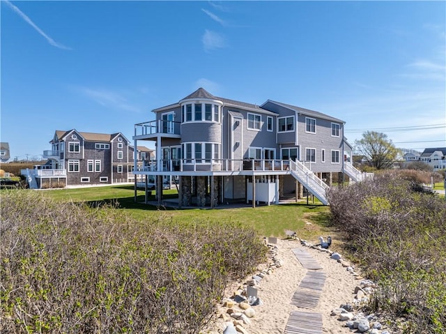 53 Stanton Ave, Narragansett, RI 02882 - back of property with stairs, a lawn, and a wooden deck
