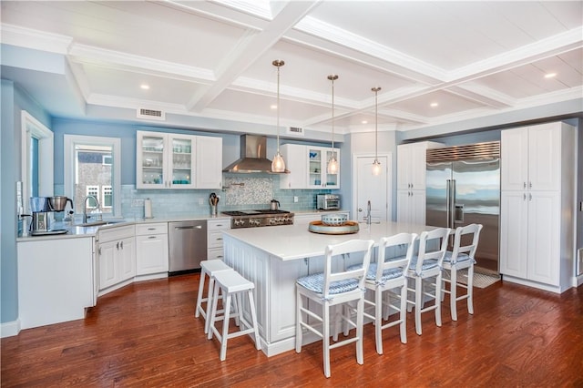 53 Stanton Ave, Narragansett, RI 02882 - kitchen featuring decorative backsplash, wall chimney range hood, a sink, coffered ceiling, and stainless steel appliances