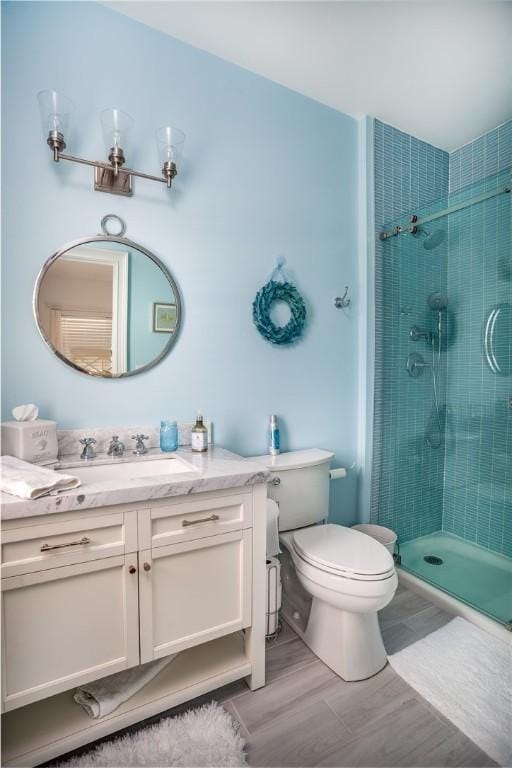 53 Stanton Ave, Narragansett, RI 02882 - bathroom featuring vanity, toilet, and a stall shower