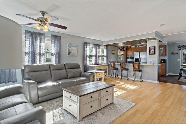 86 Quannacut Rd Unit A, Westerly, RI 02891 - living room with a ceiling fan, light wood finished floors, and baseboards