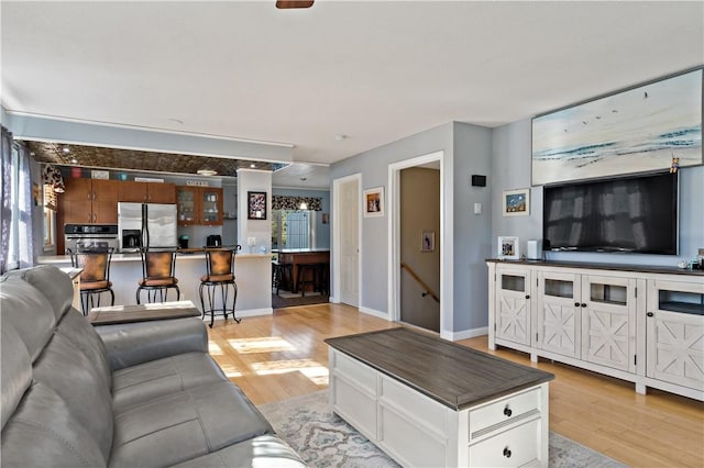 86 Quannacut Rd Unit A, Westerly, RI 02891 - living room featuring light wood-type flooring, healthy amount of natural light, and baseboards