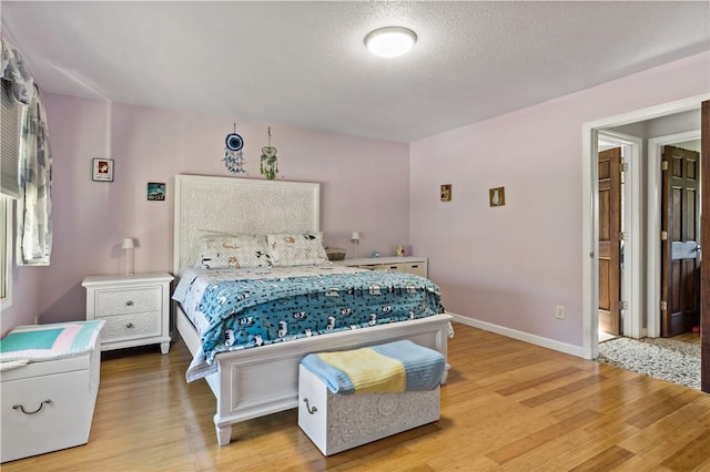 86 Quannacut Rd Unit A, Westerly, RI 02891 - bedroom with wood finished floors, baseboards, and a textured ceiling