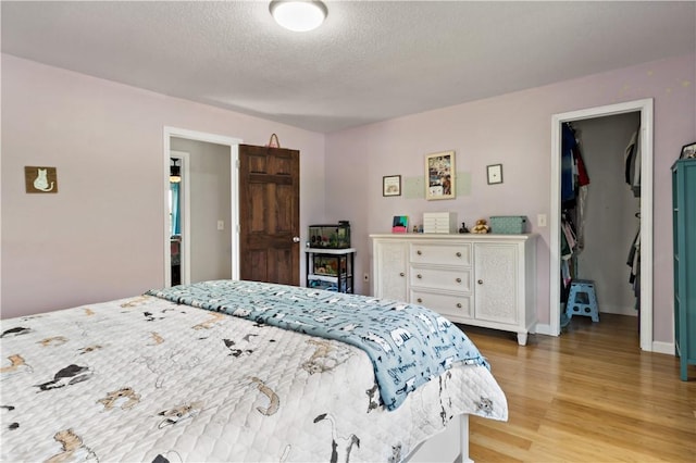 86 Quannacut Rd Unit A, Westerly, RI 02891 - bedroom featuring light wood-style floors, a textured ceiling, and baseboards