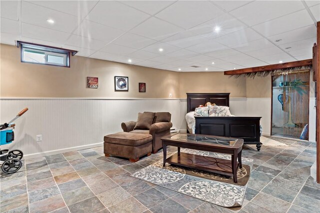 86 Quannacut Rd Unit A, Westerly, RI 02891 - living room featuring a wainscoted wall, a drop ceiling, stone finish flooring, recessed lighting, and a baseboard radiator