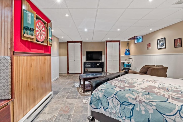 86 Quannacut Rd Unit A, Westerly, RI 02891 - bedroom featuring baseboard heating, wainscoting, wooden walls, a drop ceiling, and recessed lighting