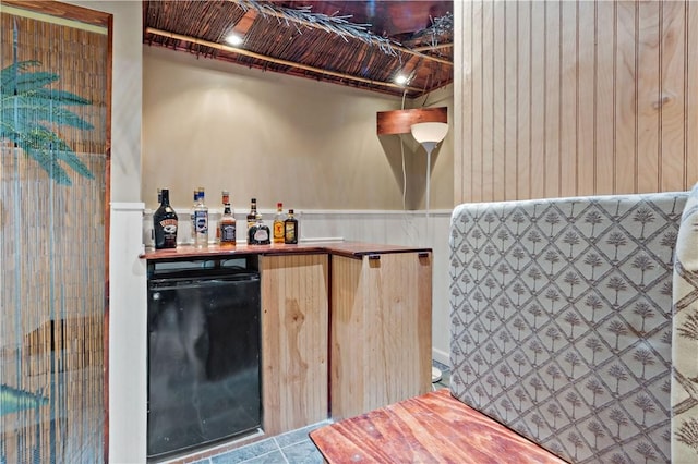 86 Quannacut Rd Unit A, Westerly, RI 02891 - indoor dry bar featuring refrigerator, a wainscoted wall, and tile patterned flooring