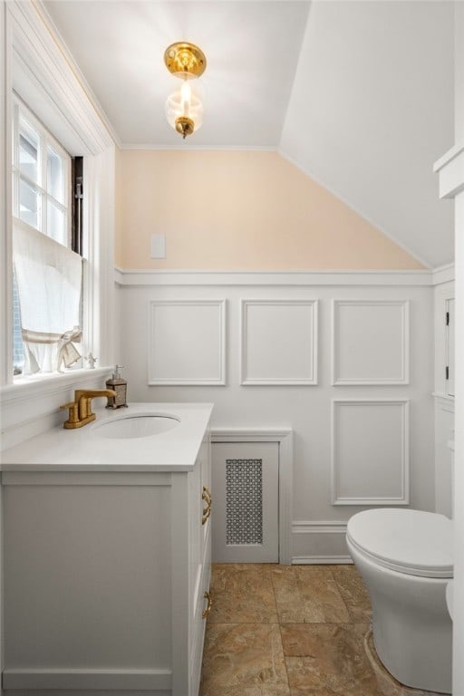 25 Seaview Ave, Cranston, RI 02905 - bathroom with vanity, a decorative wall, lofted ceiling, toilet, and stone finish floor
