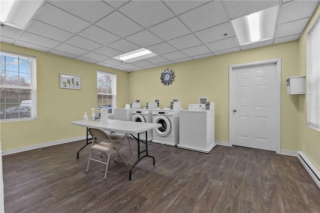 community laundry room with baseboards, a baseboard radiator, washer and dryer, and dark wood-style floors