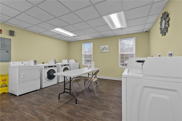 shared laundry area featuring baseboards, electric panel, dark wood finished floors, and washer and dryer