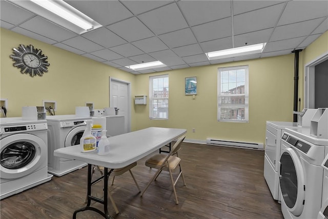 shared laundry area featuring a baseboard heating unit, dark wood-style flooring, and washing machine and dryer