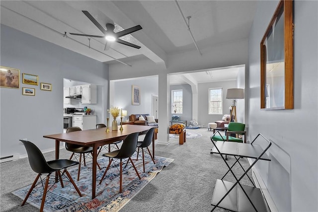 dining space featuring carpet floors, baseboards, baseboard heating, and a ceiling fan