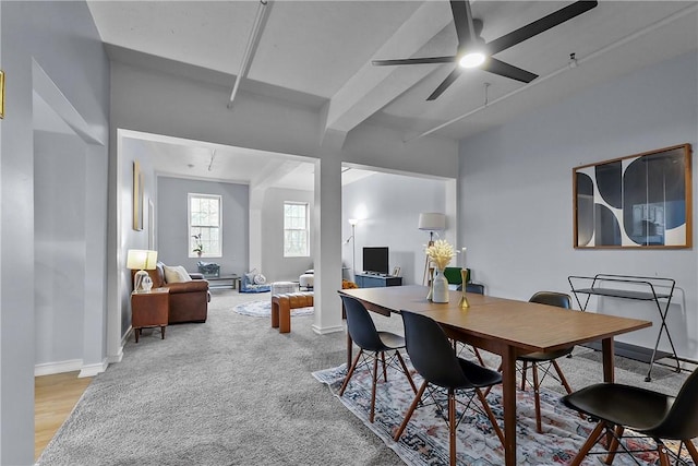 dining room with baseboards, beamed ceiling, and a ceiling fan