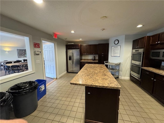 11 Cardinal Ct, Tiverton, RI 02878 - kitchen with appliances with stainless steel finishes, recessed lighting, baseboards, light tile patterned floors, and a kitchen island