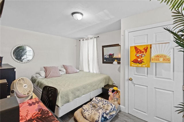 bedroom with baseboards and wood finished floors