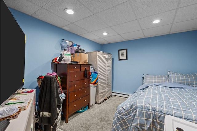 bedroom featuring recessed lighting, a baseboard radiator, a drop ceiling, and carpet flooring
