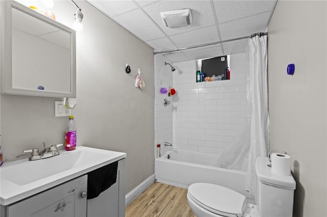 full bath with wood finished floors, baseboards, vanity, toilet, and shower / bathtub combination with curtain