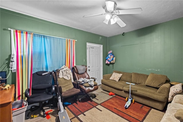 living area featuring a ceiling fan