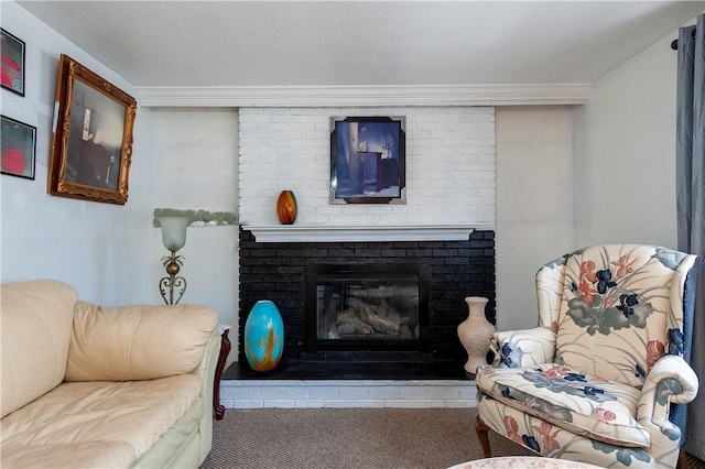 living area with carpet and a fireplace
