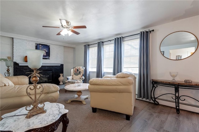 living room with a fireplace, a ceiling fan, and wood finished floors