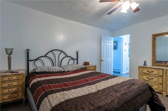 carpeted bedroom with a ceiling fan and a baseboard heating unit