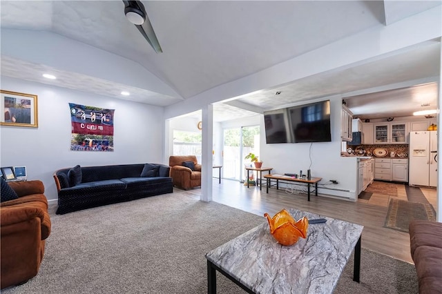 living room featuring vaulted ceiling and light wood-style flooring