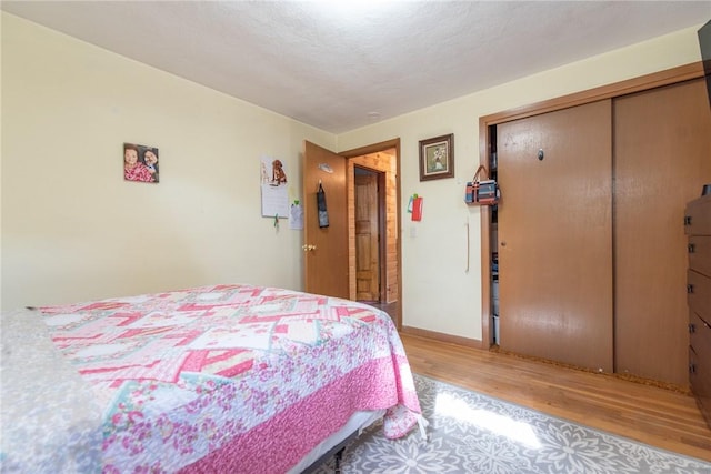 bedroom featuring a closet and wood finished floors