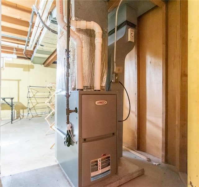 utility room featuring heating unit
