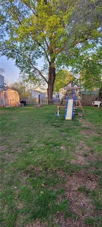view of yard featuring a playground and fence