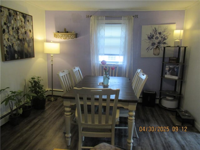 dining space with wood finished floors and baseboard heating