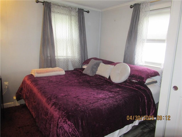 bedroom featuring crown molding and carpet flooring