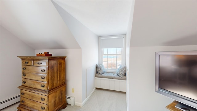 bedroom with a baseboard radiator, baseboard heating, lofted ceiling, and light carpet