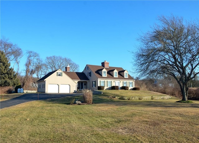 cape cod home featuring a garage, a chimney, a front lawn, and aphalt driveway