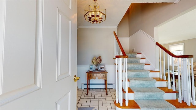 staircase featuring a baseboard heating unit and a chandelier