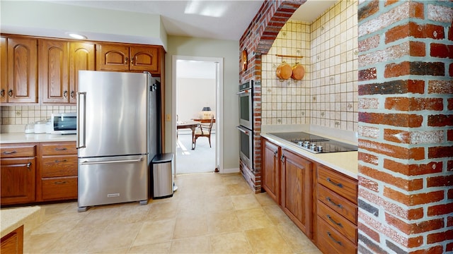 kitchen with brown cabinetry, light countertops, tasteful backsplash, and stainless steel appliances